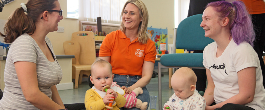 Home Start volunteer chatting to mums about breastfeeding.
