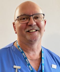 Smiling male health care assistant in uniform