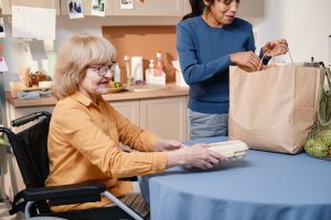 healthcare assistant helping patient with food shopping 