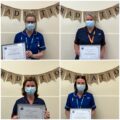 Nurses stood with graduation certificates