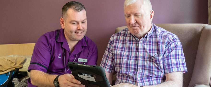 Care home staff providing support to a resident.