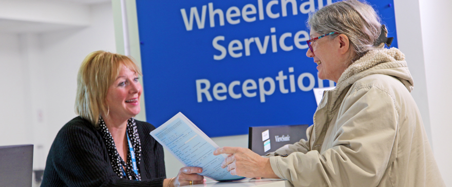 Service user talking the the receptionist at the Wheelchair Service.