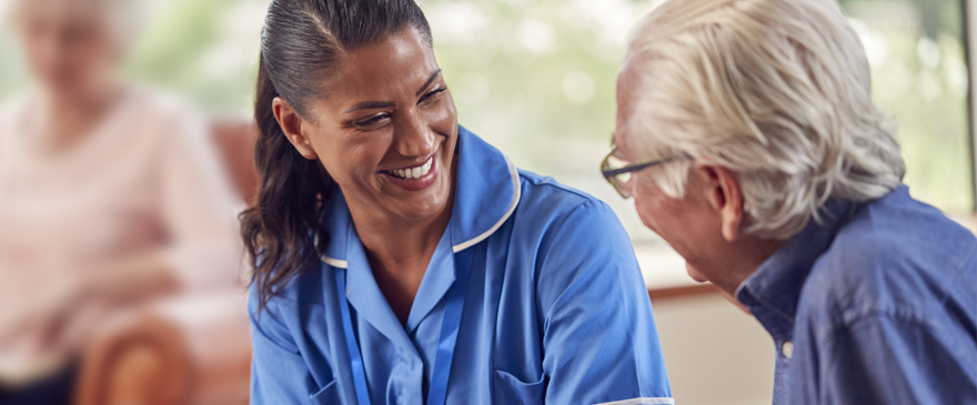 Nurse smiling at a patient.