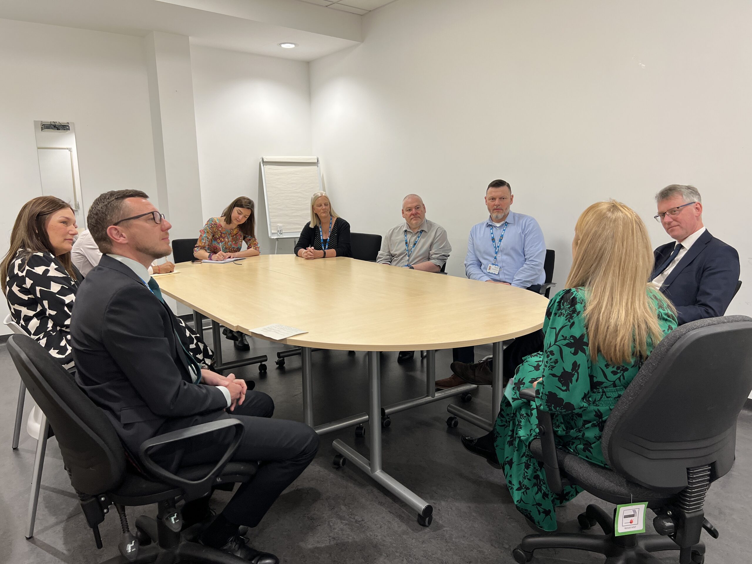 NHS staff and NHS Providers visitors sat around a board room table