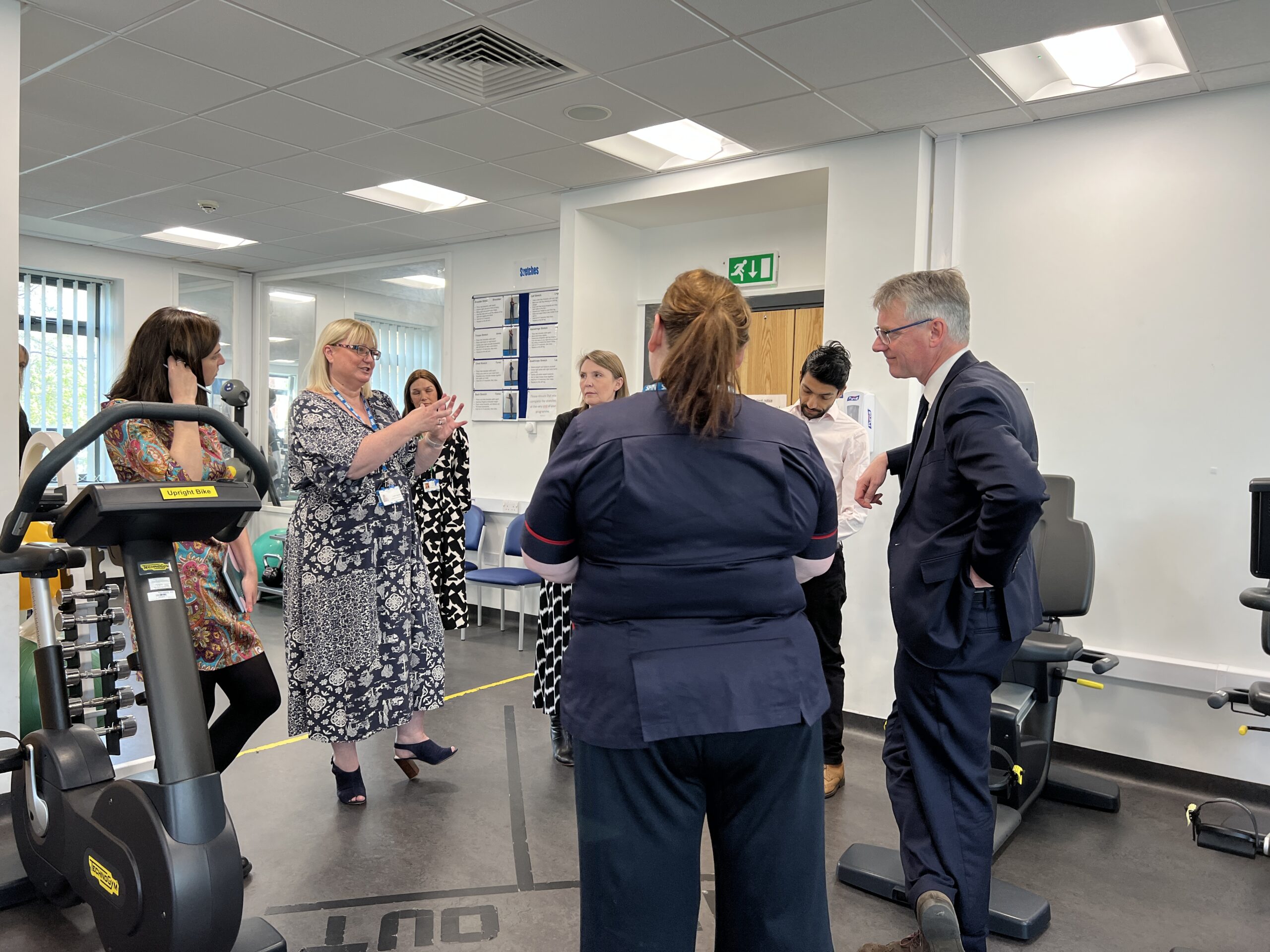 NHS Providers visitors and WCHC Staff stood in the Cardiac Rehab gym