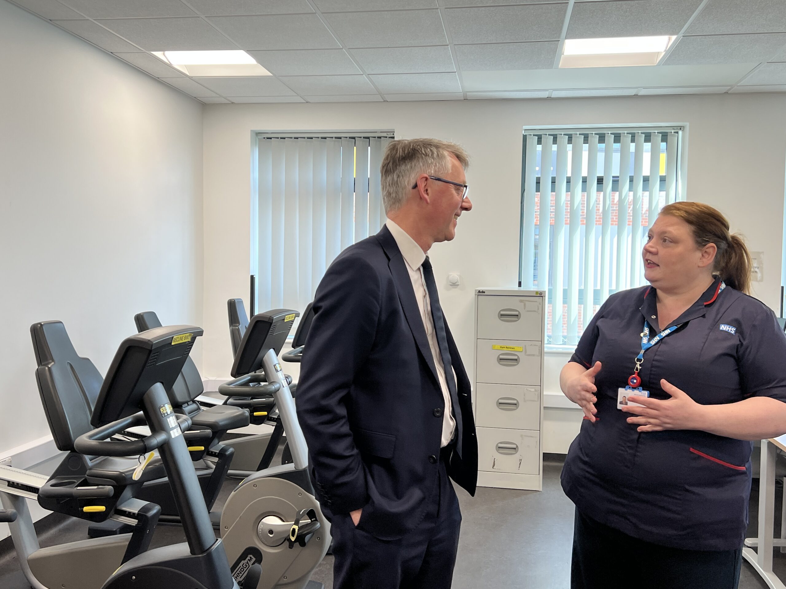 Sir Julian Hartley talking to the Community Cardiology Service Lead in the gym