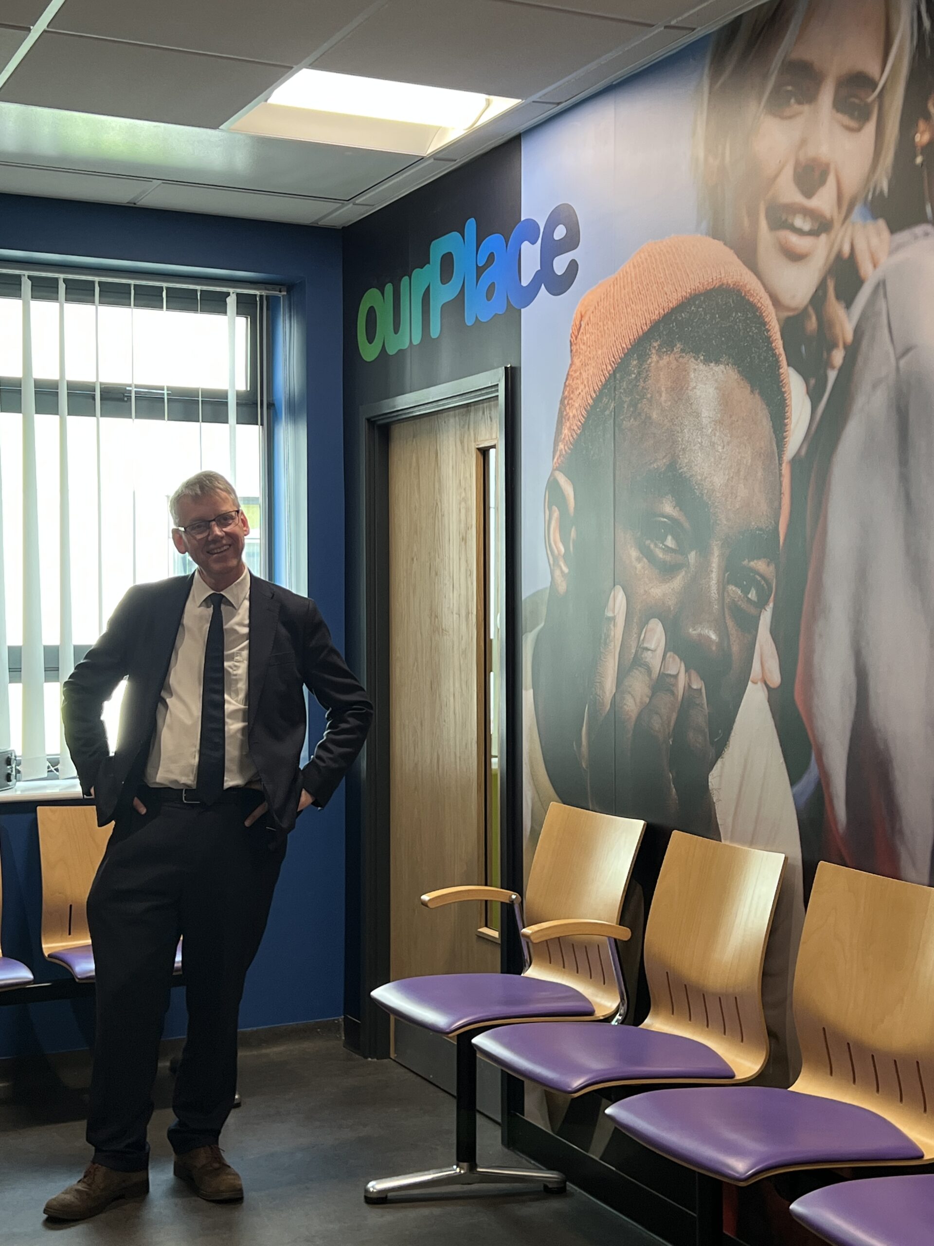 Sir Julian Hartley stood in the new ourPlace waiting room