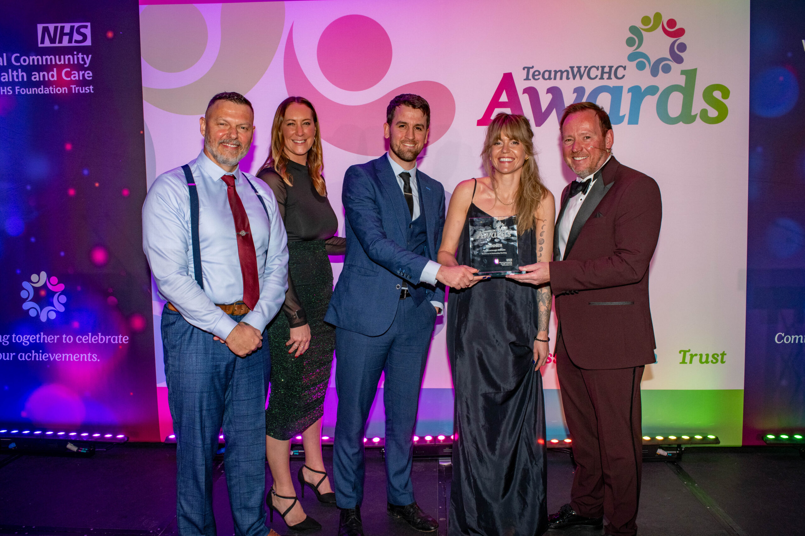 Staff accepting award on stage