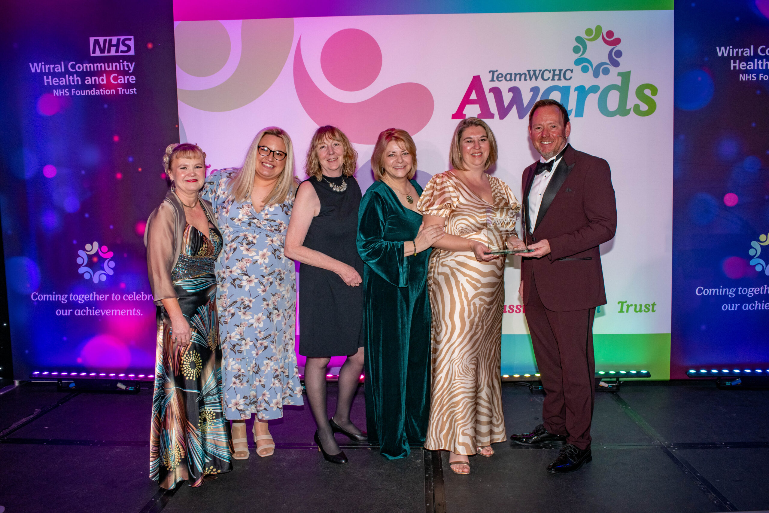 Staff accepting award on stage