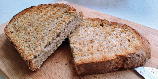 Image of a piece of brown toast cut in half. 