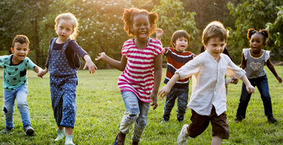 Children running and playing on the grass