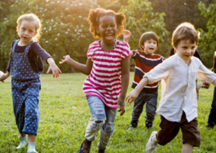 Children running and playing on the grass