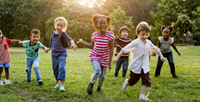 children running outside on grass