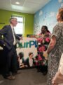 Sir Julian Hartley in the ourPlace reception with Service Lead and Service Development Coordinator