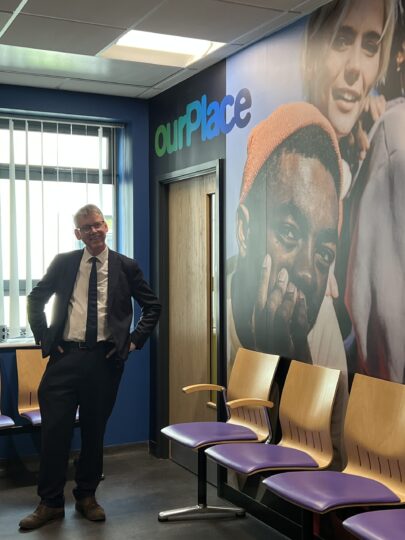 Sir Julian Hartley stood in the new ourPlace waiting room