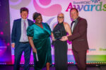 Staff accepting award on stage