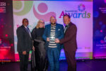 Staff accepting award on stage