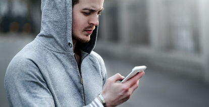 Young person looking at their phone.