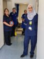 Clinical staff in uniform smiling with gifts of chocolate