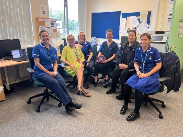 Group of clinical staff in uniform, smiling