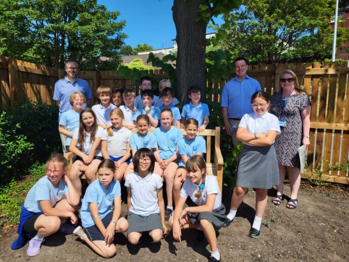 Group of primary school children in a sunny garden