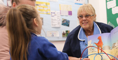 Health visitor helping parent and child