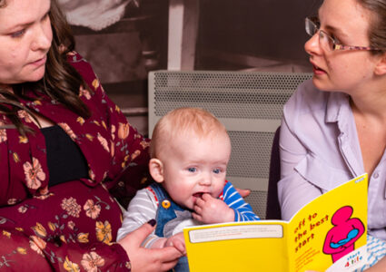 Parent and child with health visitor