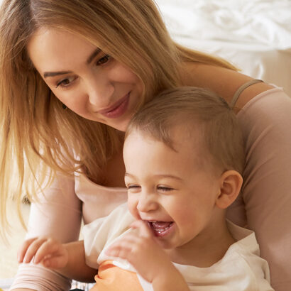 Mum holding her giggling baby