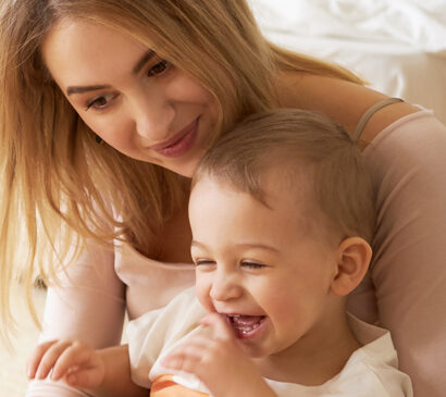 Mum holding her giggling baby